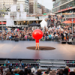 Person håller en stor röd boll framför sig på en scen. Foto: Eva Dalin