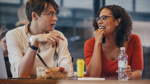 A male student and a female student having lunch.