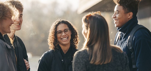 Students in a group outside talking